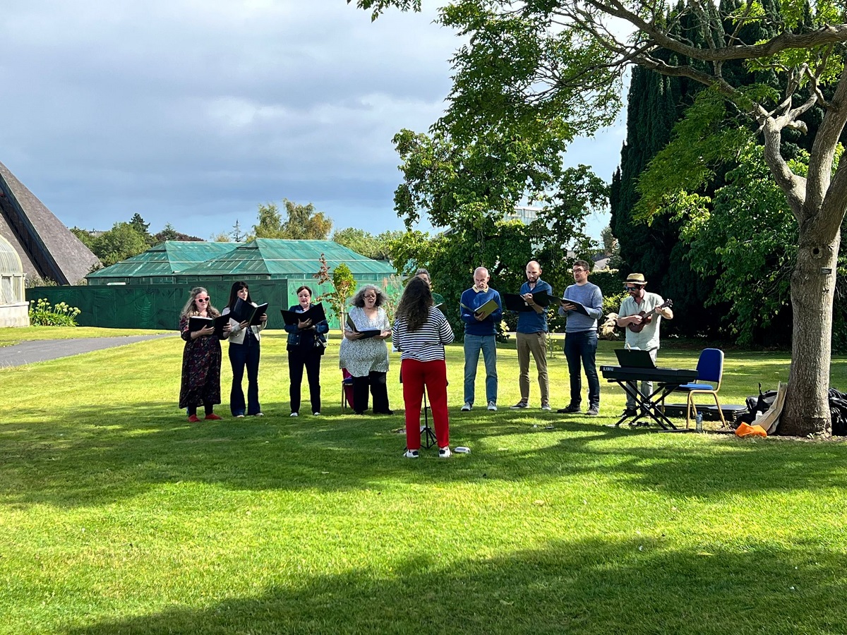 Met Éireann’s choir singing outdoors.